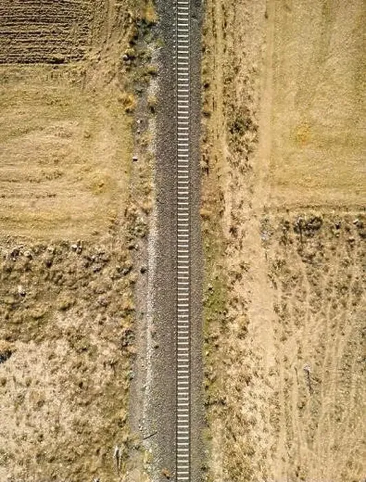 Framed Print : Top view of the train track passing through the arid land, taken with a drone Framed Print : Top view of the train track passing through the arid land, taken with a drone
