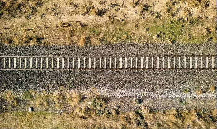 Framed Print : Top view of the train track passing through the arid land, taken with a drone Framed Print : Top view of the train track passing through the arid land, taken with a drone