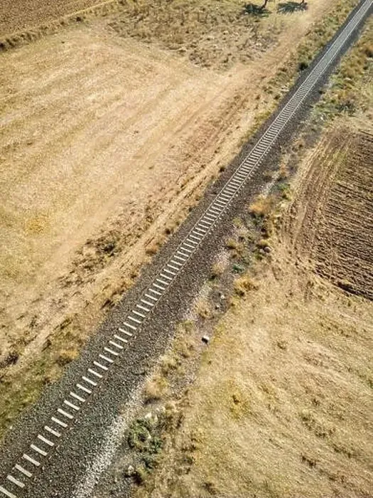 Framed Print : Top view of the train track passing through the arid land, taken with a drone Framed Print : Top view of the train track passing through the arid land, taken with a drone
