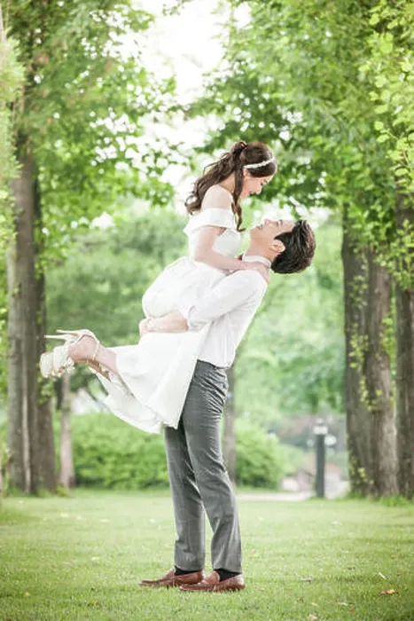 Framed Print : Side view of young romantic wedding couple holding face to face outdoors Framed Print : Side view of young romantic wedding couple holding face to face outdoors