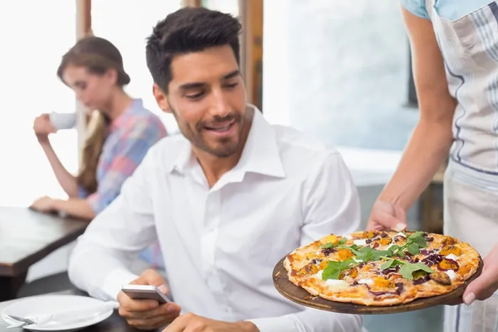 Framed Print : Waitress giving pizza to man at coffee shop Framed Print : Waitress giving pizza to man at coffee shop