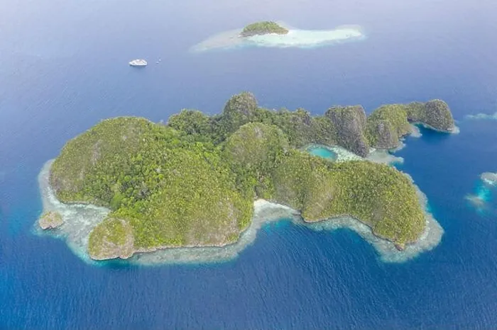 Framed Print : Warm seas surround rugged limestone islands in Raja Ampat, Indonesia. This area is known as the Coral Triangle due to its high marine biodiversity Framed Print : Warm seas surround rugged limestone islands in Raja Ampat, Indonesia. This area is known as the Coral Triangle due to its high marine biodiversity
