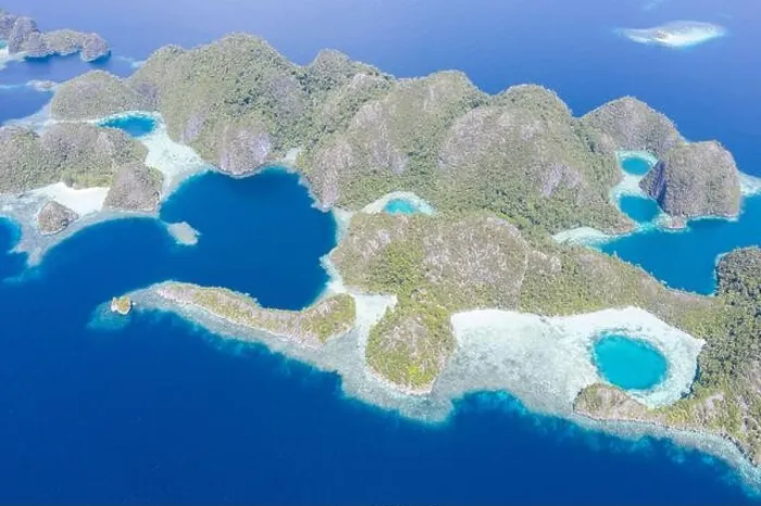 Framed Print : Warm seas surround rugged limestone islands in Raja Ampat, Indonesia. This area is known as the Coral Triangle due to its high marine biodiversity Framed Print : Warm seas surround rugged limestone islands in Raja Ampat, Indonesia. This area is known as the Coral Triangle due to its high marine biodiversity