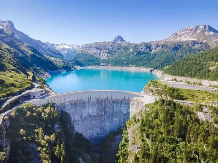 Framed Print : Water dam and reservoir lake aerial view in Alps mountains in summer generating hydroelectricity Framed Print : Water dam and reservoir lake aerial view in Alps mountains in summer generating hydroelectricity