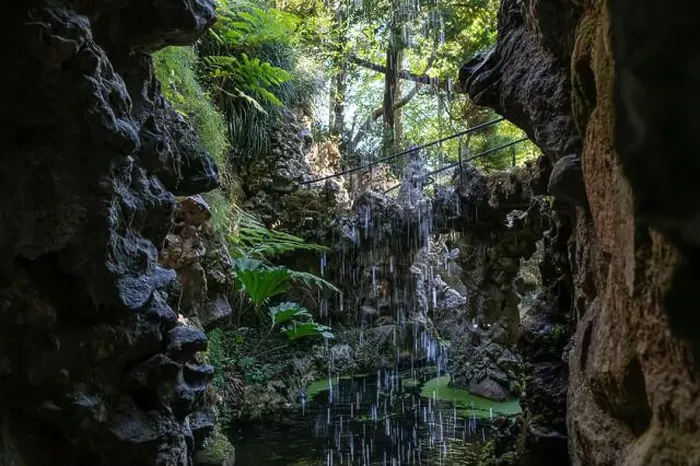 Framed Print : Water trickles down rocky cliffs into a peaceful pond, surrounded by vibrant foliage Framed Print : Water trickles down rocky cliffs into a peaceful pond, surrounded by vibrant foliage