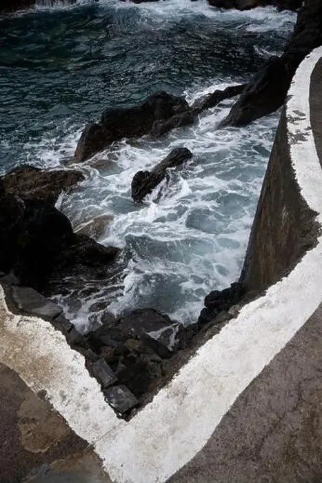 Framed Print : Waves crash against volcanic rocks beneath a sharp concrete edge at Porto Moniz natural pools Framed Print : Waves crash against volcanic rocks beneath a sharp concrete edge at Porto Moniz natural pools