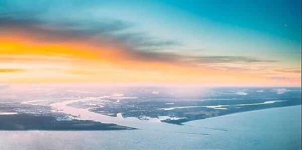 Western Dvina Flows Into The Baltic Sea. River Divides The Northern And Kurzeme District Of Riga, Latvia. View From Airplane Flight. Sunset Sunrise Ov