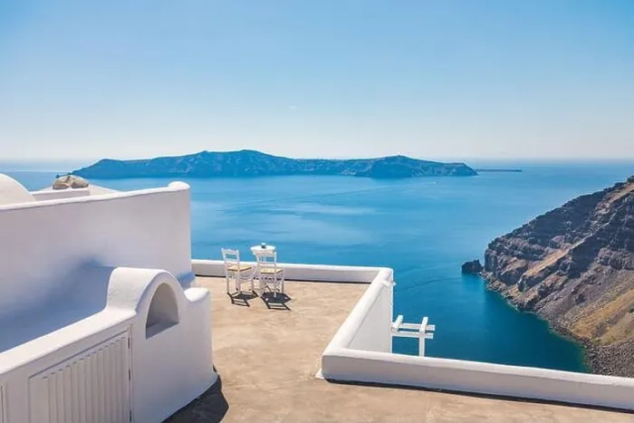 Framed Print : White architecture on Santorini island, Greece. Outdoor restaurant under a fantastic sunset landscape, chairs couple. Romantic view, summer vacation Framed Print : White architecture on Santorini island, Greece. Outdoor restaurant under a fantastic sunset landscape, chairs couple. Romantic view, summer vacation