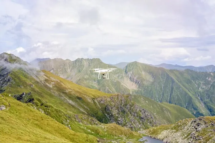 Framed Print : White drone flying in Fagaras Mountains, near Paltinului saddle. Bright sky with clouds on background. Romania Framed Print : White drone flying in Fagaras Mountains, near Paltinului saddle. Bright sky with clouds on background. Romania