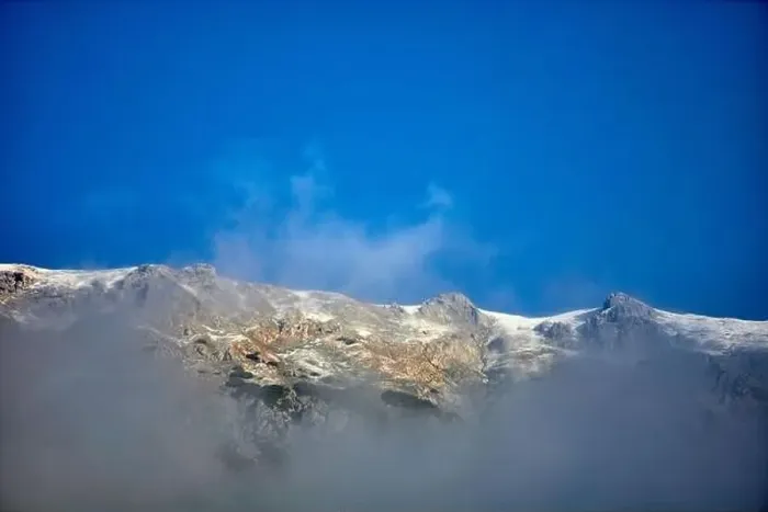 Framed Print : a white mountains with fog and blue sky Framed Print : a white mountains with fog and blue sky