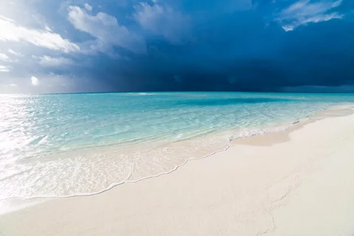 Framed Print : White tropical beach in Maldives with blue lagoon and a tropical storm Framed Print : White tropical beach in Maldives with blue lagoon and a tropical storm