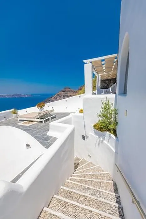 Framed Print : White wash staircases on Santorini Island, Greece. Caldera sea view, vertical travel panorama. Blue sunny sky Framed Print : White wash staircases on Santorini Island, Greece. Caldera sea view, vertical travel panorama. Blue sunny sky
