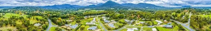 Framed Print : Wide aerial panorama of scenic countryside with houses surrounded by forest and mountains Framed Print : Wide aerial panorama of scenic countryside with houses surrounded by forest and mountains