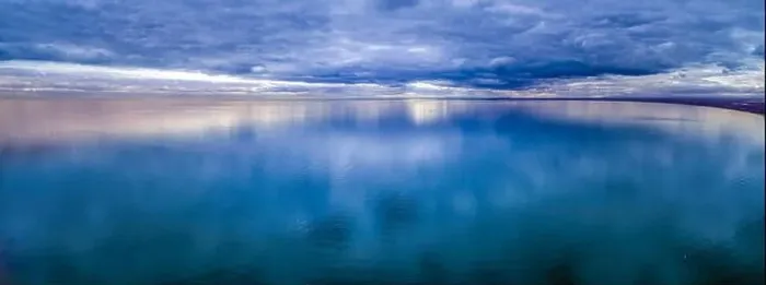 Framed Print : Wide aerial panorama of stormy clouds over smooth ocean water surface Framed Print : Wide aerial panorama of stormy clouds over smooth ocean water surface