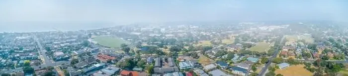 Framed Print : Wide aerial panorama of suburbs covered in smoke haze from bush fires in Gippsland, Victoria, Australia Framed Print : Wide aerial panorama of suburbs covered in smoke haze from bush fires in Gippsland, Victoria, Australia