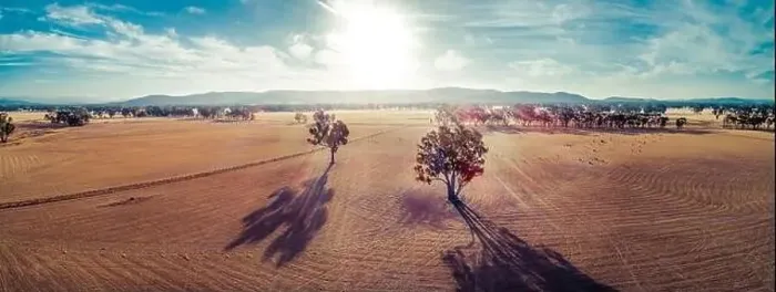 Framed Print : Wide aerial panorama of sunset over fields in Australian outback with lens flare