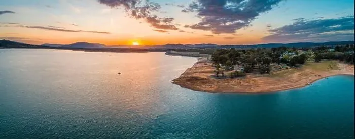 Framed Print : Wide aerial panorama of a tiny boat in big lake at sunset with copy space Framed Print : Wide aerial panorama of a tiny boat in big lake at sunset with copy space