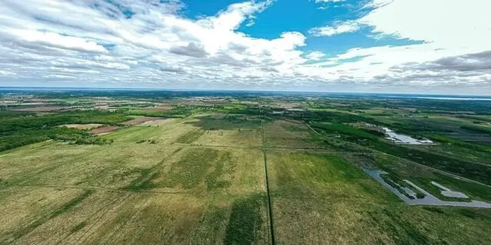 Framed Print : A very wide aerial view of farmland and rural wisconsin in spring under a cloudy blue sky Framed Print : A very wide aerial view of farmland and rural wisconsin in spring under a cloudy blue sky