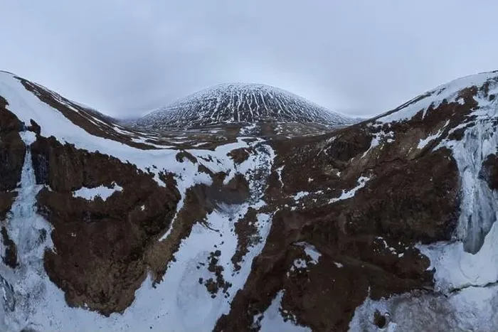 Framed Print : Wide angle drone view of snowy mountains under cloudy gloomy sky in Iceland Framed Print : Wide angle drone view of snowy mountains under cloudy gloomy sky in Iceland
