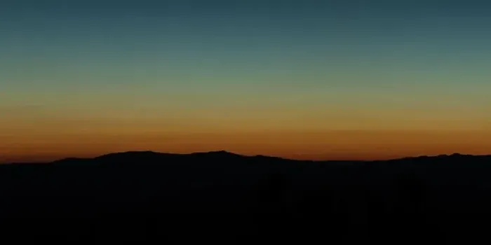 Framed Print : Wide angle panorama silhouette mountain tops in orange blue gradient sunset