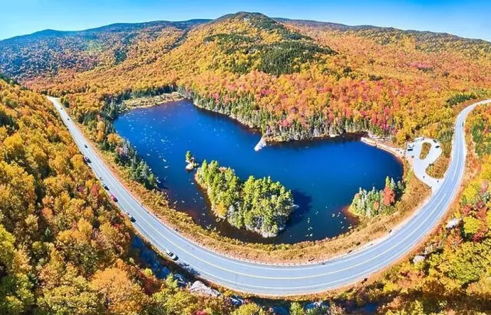 Framed Print : Wide panorama aerial over highway through stunning peak fall foliage New Hampshire mountains around blue lake Framed Print : Wide panorama aerial over highway through stunning peak fall foliage New Hampshire mountains around blue lake