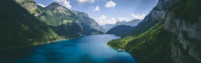 Framed Print : wide panorama aerial view of deep blue mountain lake and tree in swiss alps, klontalersee switzerland Framed Print : wide panorama aerial view of deep blue mountain lake and tree in swiss alps, klontalersee switzerland