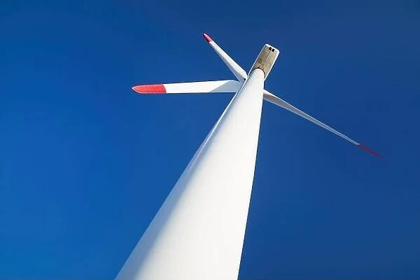 Wind turbine against blue sky background