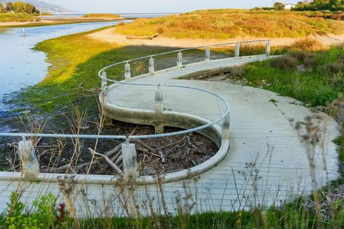 Framed Print : Winding boardwalk surrounded by greenery and water at Malibu Lagoon in California. Coastal landscape Framed Print : Winding boardwalk surrounded by greenery and water at Malibu Lagoon in California. Coastal landscape