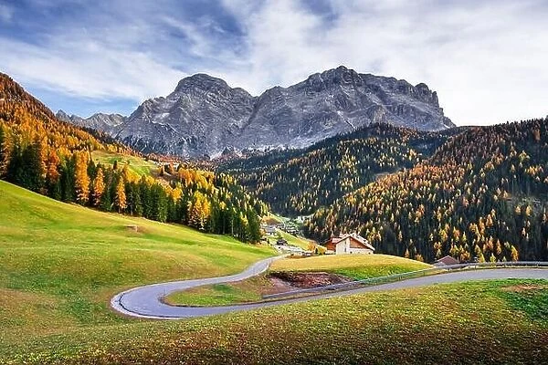 Winding road at the autumn Dolomite Alps. Amazing landscape with mountains on background at San Genesio village location, Province of Bolzano