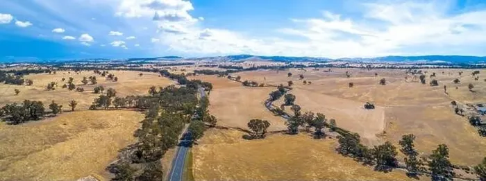 Framed Print : Winding road and small creek passing through agricultural land on a sunny day in Victoria, Australia - aerial panorama Framed Print : Winding road and small creek passing through agricultural land on a sunny day in Victoria, Australia - aerial panorama