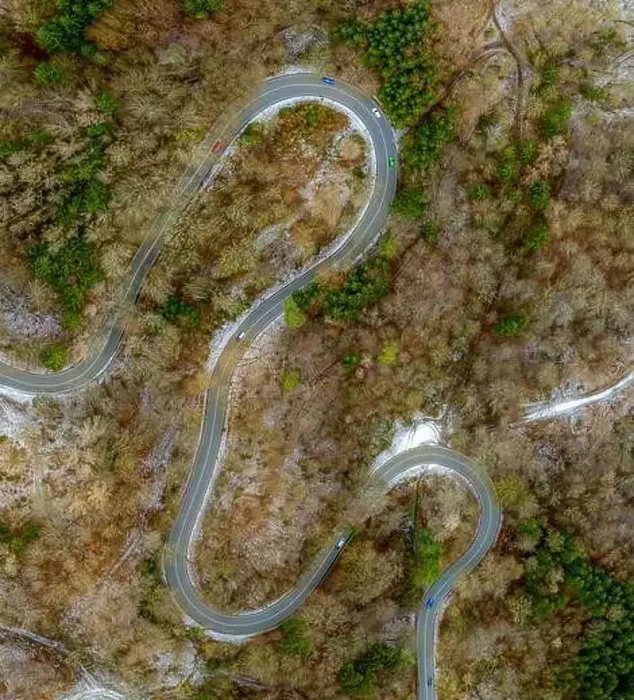 Framed Print : Winding road in the transition from autumn to winter, snow at a germany roa, filmed straight from above Framed Print : Winding road in the transition from autumn to winter, snow at a germany roa, filmed straight from above