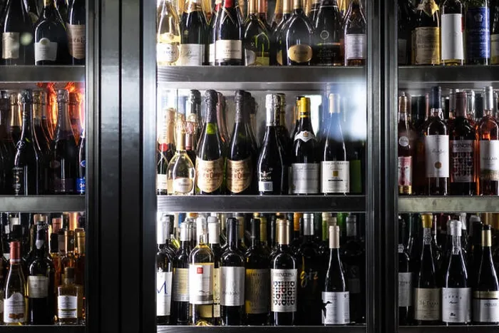 Framed Print : Wine bottles in large cooler fridge at a restaurant Framed Print : Wine bottles in large cooler fridge at a restaurant