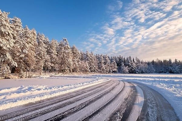 Winter landscape with ice road and bright sunny day in Finland