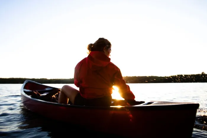 Framed Print : A woman canoes on Cobbosseecontee Lake, in southern Maine