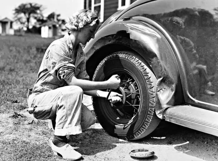 Framed Print : Woman changing a tire, 1937 Framed Print : Woman changing a tire, 1937