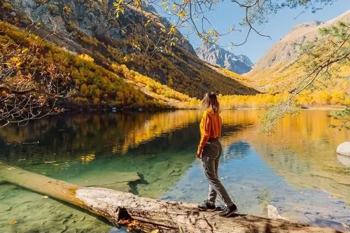 Framed Print : Woman at crystal lake in the autumnal mountains. Mountain lake and traveller woman Framed Print : Woman at crystal lake in the autumnal mountains. Mountain lake and traveller woman