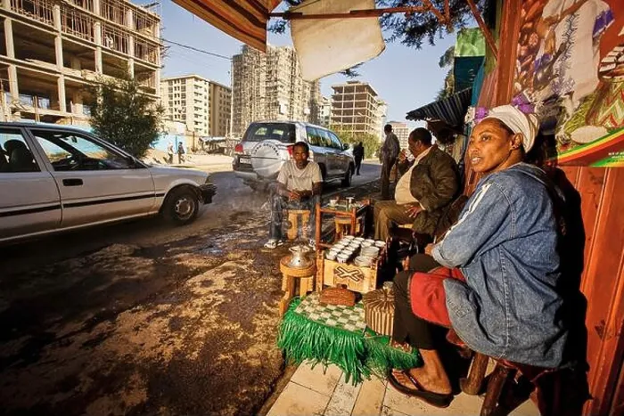 Framed Print : A woman cultivates the Ethiopian coffee tradition in her street bar in a development area