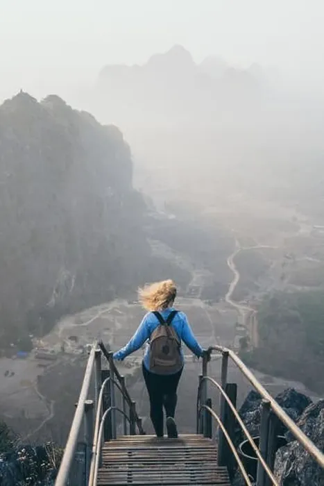 Framed Print : Woman in denim shirt standing on mountain peak with stairs going down during sunrise foggy morning in Hpa-An, Myanmar Framed Print : Woman in denim shirt standing on mountain peak with stairs going down during sunrise foggy morning in Hpa-An, Myanmar
