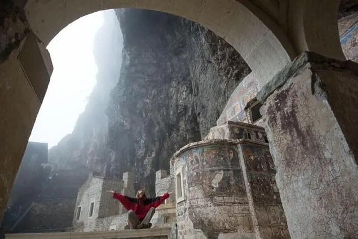 Framed Print : Woman dressed in red clothes meditates in Sumela Monastery (Turkey) Framed Print : Woman dressed in red clothes meditates in Sumela Monastery (Turkey)