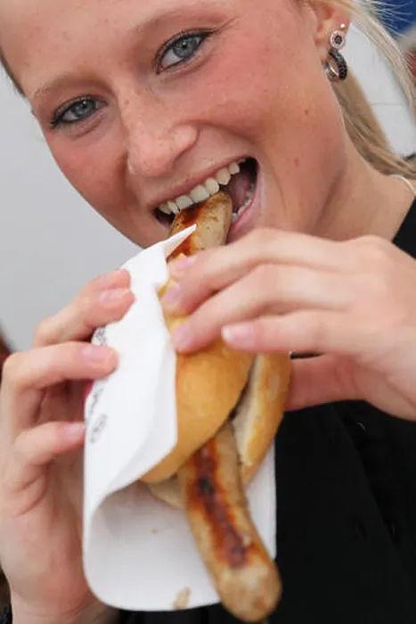Framed Print : A woman eats bratwurst during the First Franconian Bratwurt summit meeting in Pegnitz Framed Print : A woman eats bratwurst during the First Franconian Bratwurt summit meeting in Pegnitz