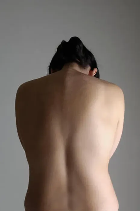 Framed Print : a woman on his back with gray background, head down Framed Print : a woman on his back with gray background, head down