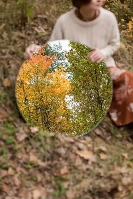 Framed Print : Woman holding mirror with autumn trees reflection Framed Print : Woman holding mirror with autumn trees reflection