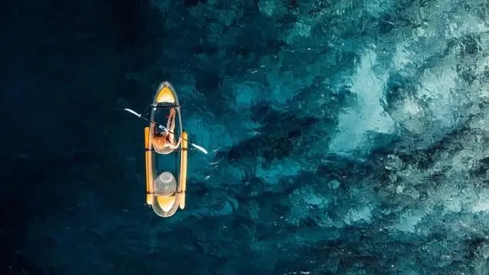Framed Print : Woman kayaking in blue ocean on transparent kayak. Drone view with copy space Framed Print : Woman kayaking in blue ocean on transparent kayak. Drone view with copy space