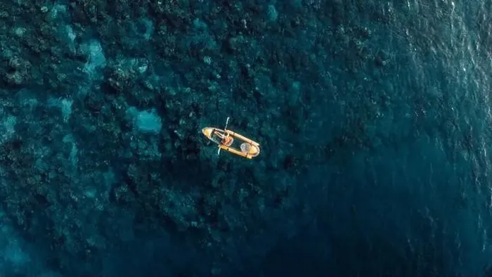 Framed Print : Woman kayaking in blue sea on transparent kayak. Drone view Framed Print : Woman kayaking in blue sea on transparent kayak. Drone view