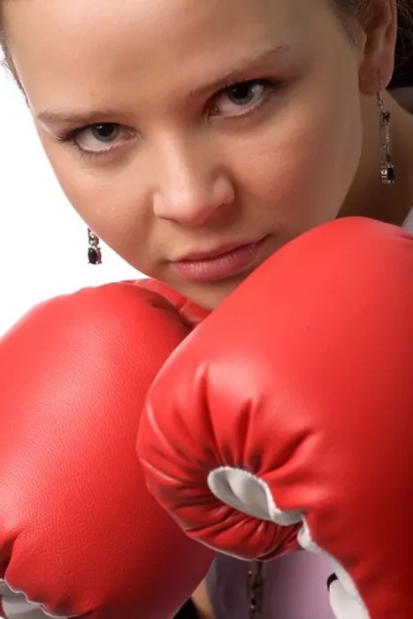 Framed Print : serious woman in red boxing gloves closeup Framed Print : serious woman in red boxing gloves closeup