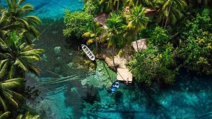 Framed Print : Woman sitting on pier in transparent lake with transparent blue water in Indonesia. Aerial view Framed Print : Woman sitting on pier in transparent lake with transparent blue water in Indonesia. Aerial view