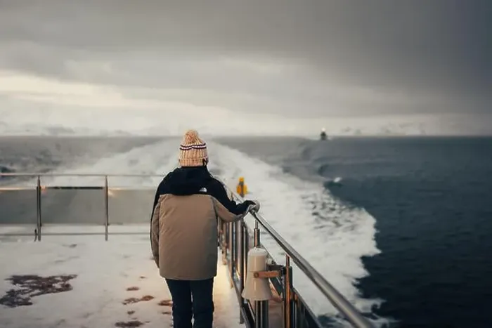 Framed Print : Woman stood holding boat rail on Norwegian fjord in the arctic Framed Print : Woman stood holding boat rail on Norwegian fjord in the arctic