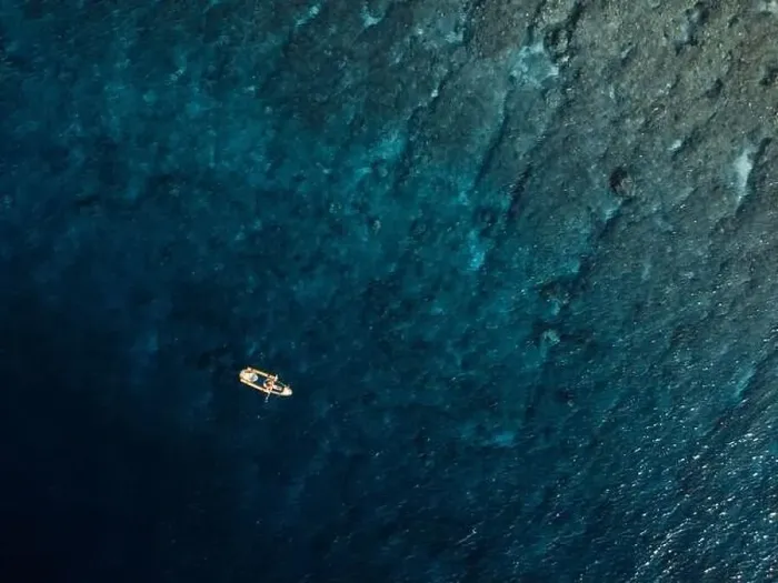 Framed Print : Woman swims on kayak in blue ocean. Drone view Framed Print : Woman swims on kayak in blue ocean. Drone view