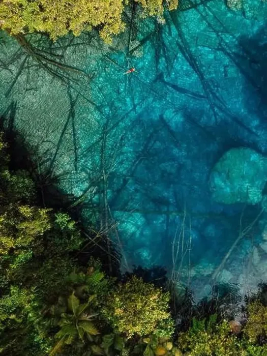 Framed Print : Woman swims in tropical transparent lake with crystal water in Sulawesi, Indonesia. Aerial view Framed Print : Woman swims in tropical transparent lake with crystal water in Sulawesi, Indonesia. Aerial view