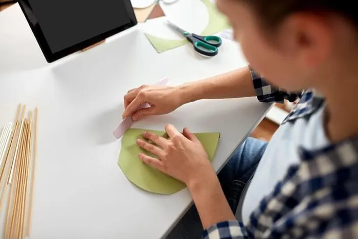 Framed Print : woman with tablet pc making paper craft at home Framed Print : woman with tablet pc making paper craft at home